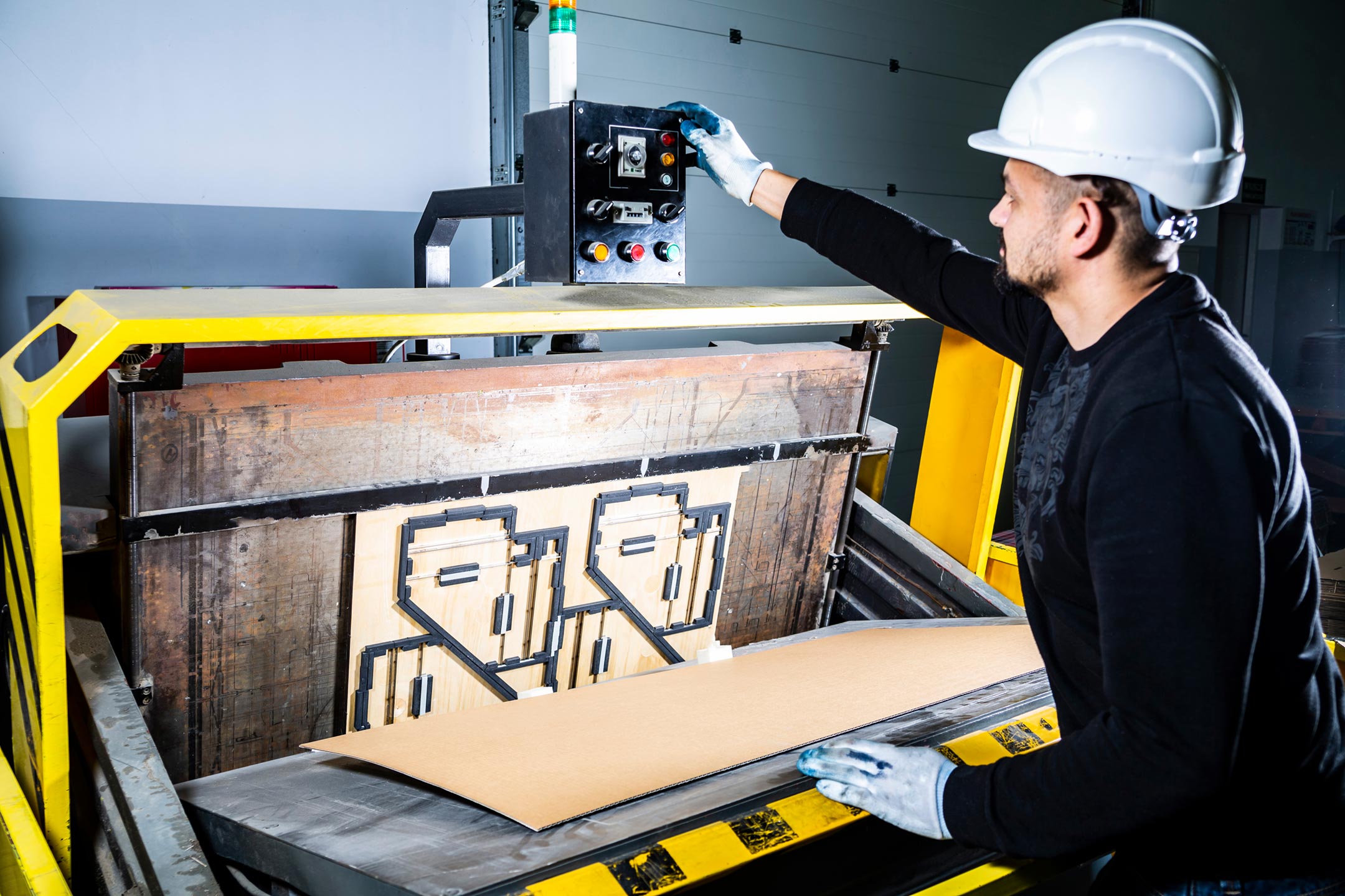 warning signs your die cutter needs service – Die cutter operator adjusting machine settings